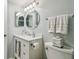Bright bathroom with a decorative vanity, oval mirror, and towel rack at 3505 Tarpon Woods Blvd # P404, Palm Harbor, FL 34685