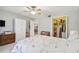 Bedroom with ceiling fan, floral bedding, closet, and a view of dining area at 3505 Tarpon Woods Blvd # P404, Palm Harbor, FL 34685