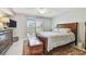 Bedroom showcasing an inviting queen bed, chest, and outdoor views through sliding glass doors at 3505 Tarpon Woods Blvd # P404, Palm Harbor, FL 34685
