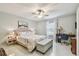 Bright bedroom with a ceiling fan, floral bedding, and a work desk at 3505 Tarpon Woods Blvd # P404, Palm Harbor, FL 34685