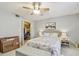 Bedroom with ceiling fan, floral bedding, and walk-in closet at 3505 Tarpon Woods Blvd # P404, Palm Harbor, FL 34685