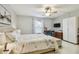 Bedroom featuring a ceiling fan, floral bedding, and a workspace at 3505 Tarpon Woods Blvd # P404, Palm Harbor, FL 34685