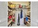 Walk-in closet filled with clothes, storage boxes, and home goods at 3505 Tarpon Woods Blvd # P404, Palm Harbor, FL 34685