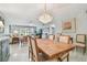 Inviting dining space with stylish chandelier and seamless flow into the cozy living area at 3505 Tarpon Woods Blvd # P404, Palm Harbor, FL 34685