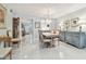 Elegant dining area with chandelier and view of the entrance hallway and a gourmet kitchen at 3505 Tarpon Woods Blvd # P404, Palm Harbor, FL 34685