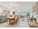 Open-concept dining area with decorative chandelier and a view into the adjacent living room at 3505 Tarpon Woods Blvd # P404, Palm Harbor, FL 34685