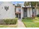 Charming condo exterior with stucco walls, red roof tiles, manicured landscaping and warm accent lighting at 3505 Tarpon Woods Blvd # P404, Palm Harbor, FL 34685