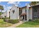 Inviting condo exterior with stucco walls, red roof tiles, and manicured landscaping at daytime at 3505 Tarpon Woods Blvd # P404, Palm Harbor, FL 34685