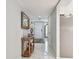 Long hallway with marble floors and console table at 3505 Tarpon Woods Blvd # P404, Palm Harbor, FL 34685