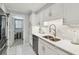 Bright white kitchen featuring stainless steel appliances, marble floors and modern lighting at 3505 Tarpon Woods Blvd # P404, Palm Harbor, FL 34685