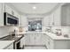 Bright, white kitchen offering stainless steel appliances and modern finishes at 3505 Tarpon Woods Blvd # P404, Palm Harbor, FL 34685