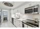 Bright white kitchen featuring stainless steel appliances, marble floors and modern lighting at 3505 Tarpon Woods Blvd # P404, Palm Harbor, FL 34685