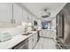 Bright white kitchen with stainless appliances, marble floors, and modern lighting at 3505 Tarpon Woods Blvd # P404, Palm Harbor, FL 34685