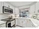 Bright, white kitchen offering stainless steel appliances and modern finishes at 3505 Tarpon Woods Blvd # P404, Palm Harbor, FL 34685