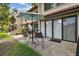 Outdoor patio with chairs, table, umbrella, and sliding glass doors at 3505 Tarpon Woods Blvd # P404, Palm Harbor, FL 34685