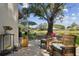Cozy condo patio setup with outdoor seating, table, grill, and relaxing water view at 3505 Tarpon Woods Blvd # P404, Palm Harbor, FL 34685