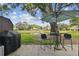 Outdoor patio with a table, chairs, grill, and water view at 3505 Tarpon Woods Blvd # P404, Palm Harbor, FL 34685
