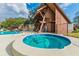 Community pool with spa, lounge chairs, and shaded pavilion at 3505 Tarpon Woods Blvd # P404, Palm Harbor, FL 34685