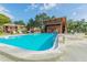 Community pool with chairs, spa, and shaded pavilion at 3505 Tarpon Woods Blvd # P404, Palm Harbor, FL 34685