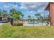Fenced community pool area with lounge chairs, spa, and lush greenery at 3505 Tarpon Woods Blvd # P404, Palm Harbor, FL 34685