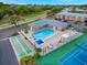 Aerial view of community pool, tennis court, shuffleboard, clubhouse, and parking area at 3580 38Th S Ave # 95, St Petersburg, FL 33711
