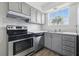 Updated kitchen boasts stainless appliances and gray cabinets at 3580 38Th S Ave # 95, St Petersburg, FL 33711