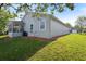 Back of home with sunroom, A/C, green grass and mulch at 37420 Teaberry Loop, Zephyrhills, FL 33542
