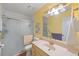 Bright bathroom with a shower, vanity, and a large mirror, offering a functional space at 37420 Teaberry Loop, Zephyrhills, FL 33542