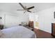 Bedroom with a ceiling fan and view to a full bathroom at 37420 Teaberry Loop, Zephyrhills, FL 33542