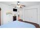 Bedroom features a ceiling fan, large closet, TV, and a blue bed with rainbow and butterfly decorations at 37420 Teaberry Loop, Zephyrhills, FL 33542