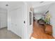 Welcoming foyer with closet and view into the spacious living room featuring hardwood floors and natural light at 37420 Teaberry Loop, Zephyrhills, FL 33542