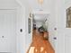 Inviting foyer with a view into the living spaces featuring hardwood floors, closet and glass paneled door at 37420 Teaberry Loop, Zephyrhills, FL 33542