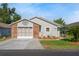 Charming home showcasing a brick-accented garage and meticulously landscaped front yard at 37420 Teaberry Loop, Zephyrhills, FL 33542