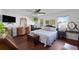 Serene main bedroom with hardwood floors, natural light, and ample space for a relaxing retreat at 37420 Teaberry Loop, Zephyrhills, FL 33542