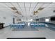 Spacious meeting room features tables and chairs ready for community gatherings and events at 37420 Teaberry Loop, Zephyrhills, FL 33542