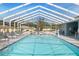 Sparkling, covered community pool with lounge chairs, offering a relaxing and shaded aquatic experience at 37420 Teaberry Loop, Zephyrhills, FL 33542