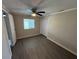 Cozy bedroom featuring neutral walls, updated flooring, and natural light at 37832 Madeira Ave, Zephyrhills, FL 33541