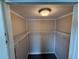 Walk-in closet features built-in shelving and overhead lighting at 37832 Madeira Ave, Zephyrhills, FL 33541