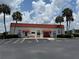 Community center with palm trees, sidewalks and ample parking spaces at 37832 Madeira Ave, Zephyrhills, FL 33541