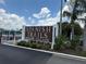 Spanish Trails Senior Village community sign with palm trees and blue sky in the background at 37832 Madeira Ave, Zephyrhills, FL 33541