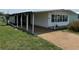 Single-story home featuring a spacious carport and landscaped front yard at 37832 Madeira Ave, Zephyrhills, FL 33541