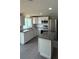 Updated kitchen with stainless steel appliances, granite counters, and center island at 37832 Madeira Ave, Zephyrhills, FL 33541