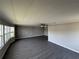 Bright living room featuring updated flooring and a wall of windows at 37832 Madeira Ave, Zephyrhills, FL 33541