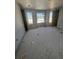 A bedroom under construction with exposed concrete floors and bright window views at 4208 W Carmen St # C, Tampa, FL 33609