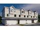 New construction townhomes featuring multiple stories, attached garages, and modern architectural design at 4208 W Carmen St # C, Tampa, FL 33609