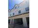 New townhome construction featuring a two-story facade with large windows and open garages at 4208 W Carmen St # C, Tampa, FL 33609