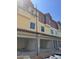 New construction townhomes are being built with open garages and yellow siding at 4208 W Carmen St # C, Tampa, FL 33609