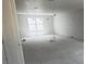 Spacious living room featuring neutral tones and large windows for natural lighting at 4208 W Carmen St # C, Tampa, FL 33609