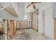 Incomplete bathroom showing exposed walls, a ceiling fan, and a single window at 4221 Burrows Rd, Zephyrhills, FL 33542