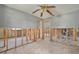 Spacious bedroom featuring exposed framing, neutral paint, and open doorway at 4221 Burrows Rd, Zephyrhills, FL 33542